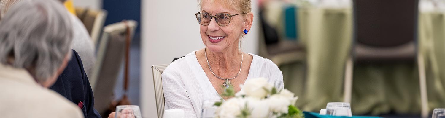A member of the Herrick Society attends the annual luncheon in September 2025.