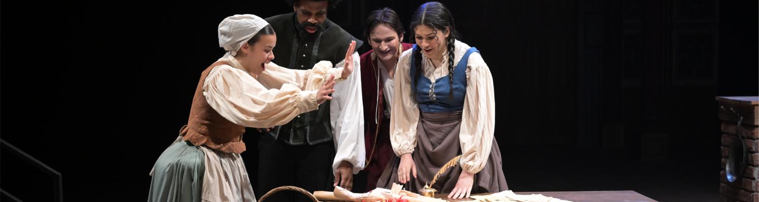 actors dressed in medieval costume perform on stage
