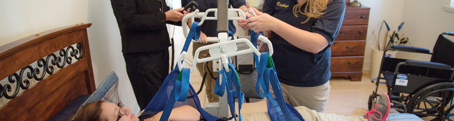 East Liverpool: In one bedroom, students use a Hoyer lift to practice transferring a patient from a wheelchair to a bed. Another bedroom simulates a hospital room so students can learn to work around cords and tubing.