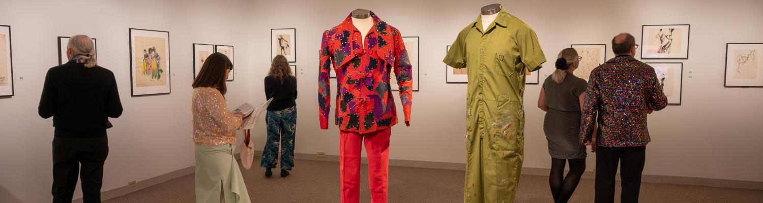Two mannequins wearing garments. Left wears long sleeve red patterned top and red pants. Right wears green short sleeve shirt and green pants