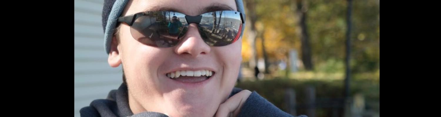 Kent State student wearing sunglasses and wool cap