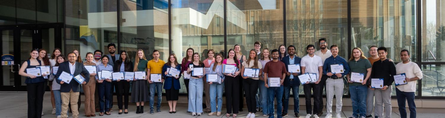 Students with their scholarship and award certificates