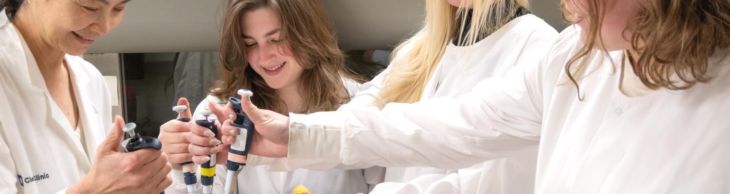 Students and a faculty advisor in a research laboratory