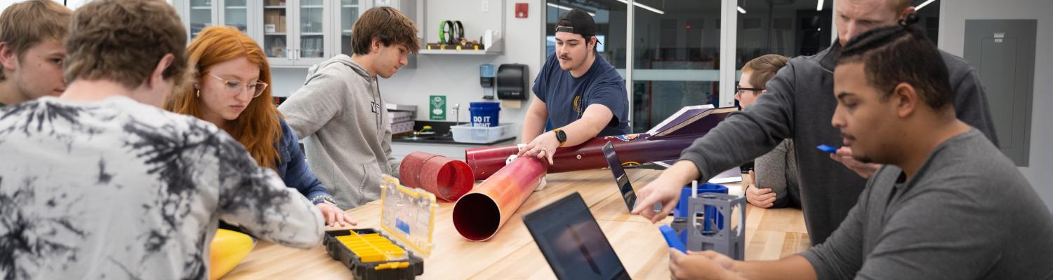 Students assemble a rocket in the Design Lab