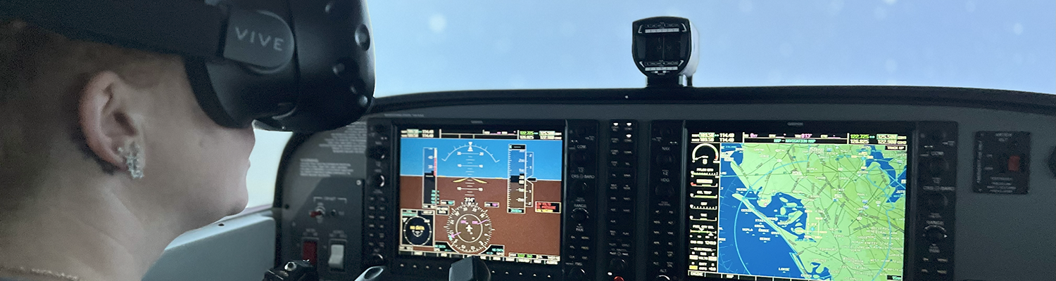 A female student conducts a simulated flight test with augmented reality goggles.