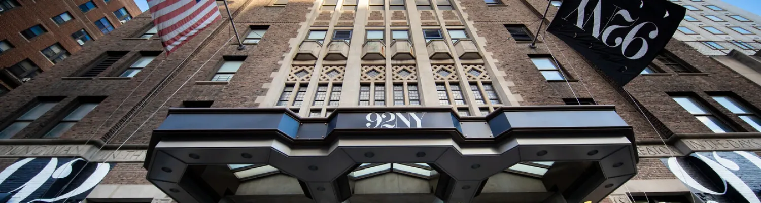 Photo of the front of the building, looking up at its sprawling windows
