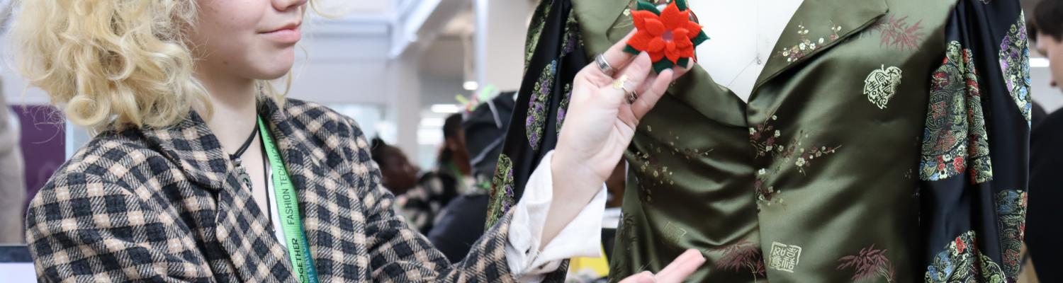 Student showcasing wearable technology on a mannequin