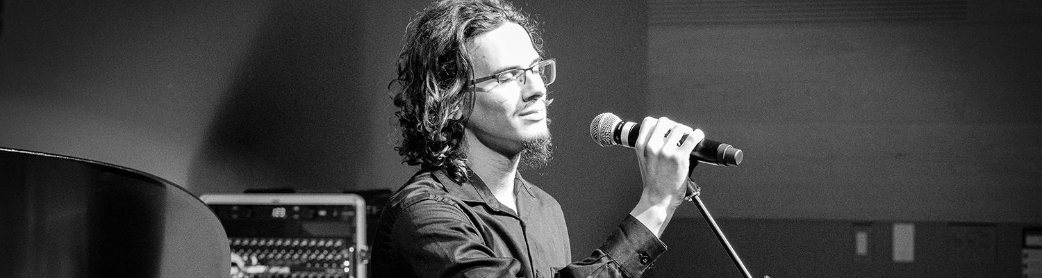 Photo of Aiden Hartley singing