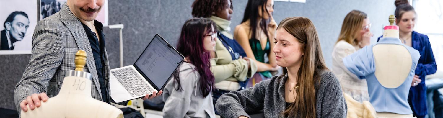 Daniel Fladung (left), assistant professor at 51’s School of Fashion, critiques a student’s work for the Salvador Dalí project. (Photo credit: Mike Rich for 51)