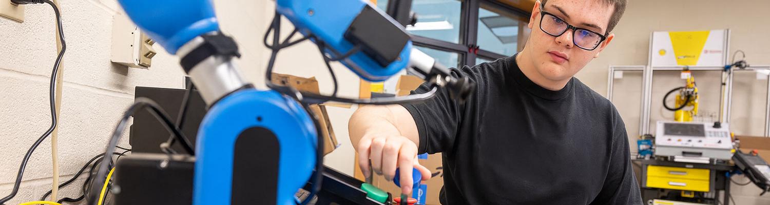 Mechanical engineering student with a robot