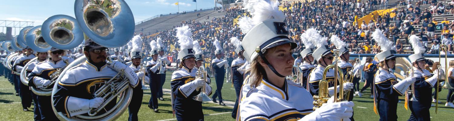 marching golden flashes on the football field during halftime