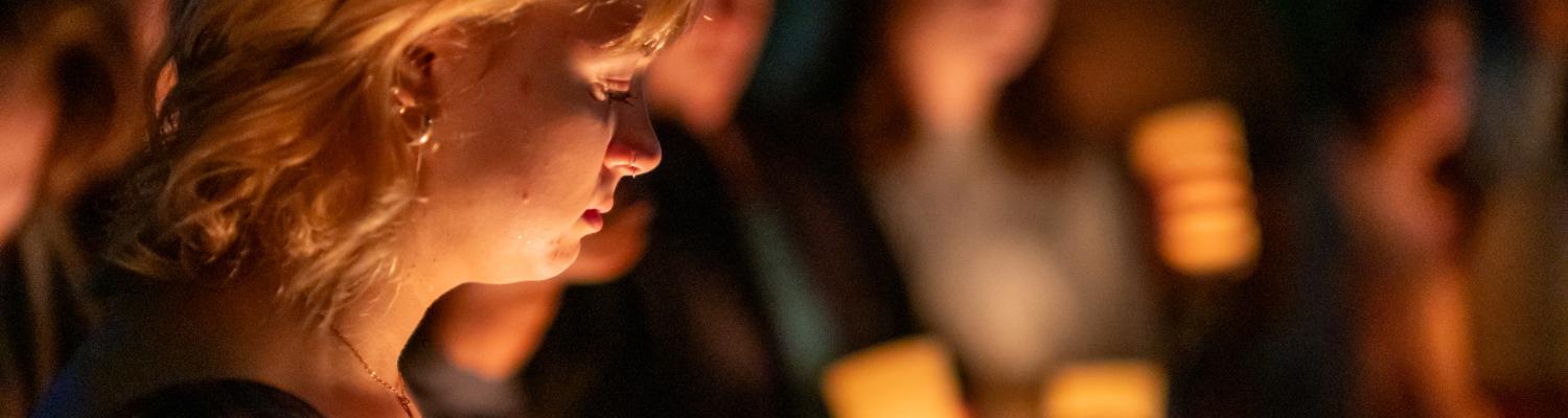 Students holding candles for May 4
