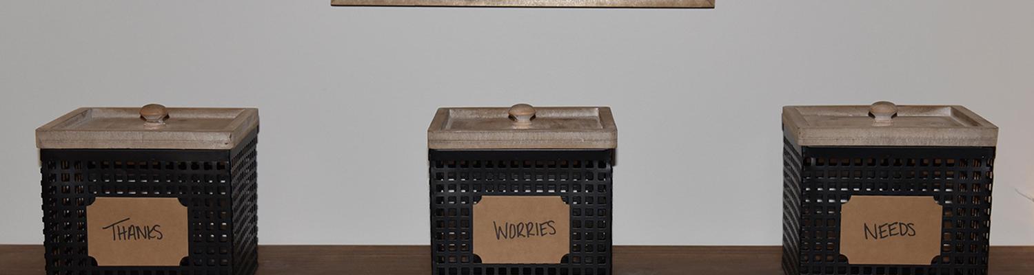 Three boxes labeled "Thanks," "Worries," and "Needs" place on a table