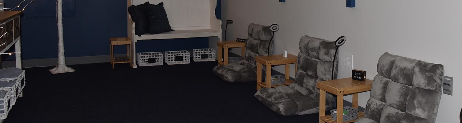 Quiet room with soft cushions, side tables, and motivational messages