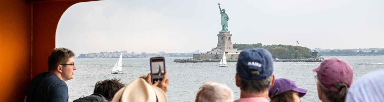 NYC Fashion; view of Statue of Liberty from ferry