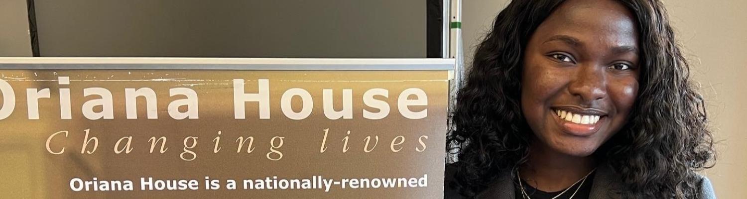 CPH alumna with Oriana House banner