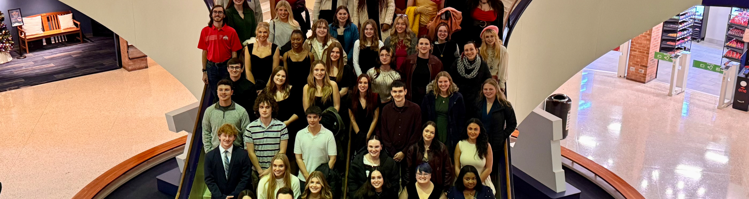 A group photo of Peer Success Academy students standing on a large staircase.