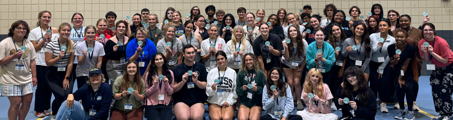 A large group of Peer Success Academy students in a gymnasium.