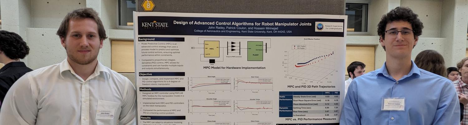 Engineering students John Radey (left) and Patrick Coulon (right) standing beside a poster describing their project, "Design of Advanced Control Algorithms for Robot Manipulator Joints."