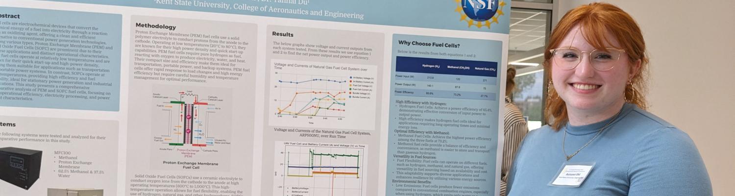 Engineering student Automn Ohl stands next to a poster describing her project: "Comparative Analysis of Proton Exchange Membrane and Solid Oxide Fuel Cells."