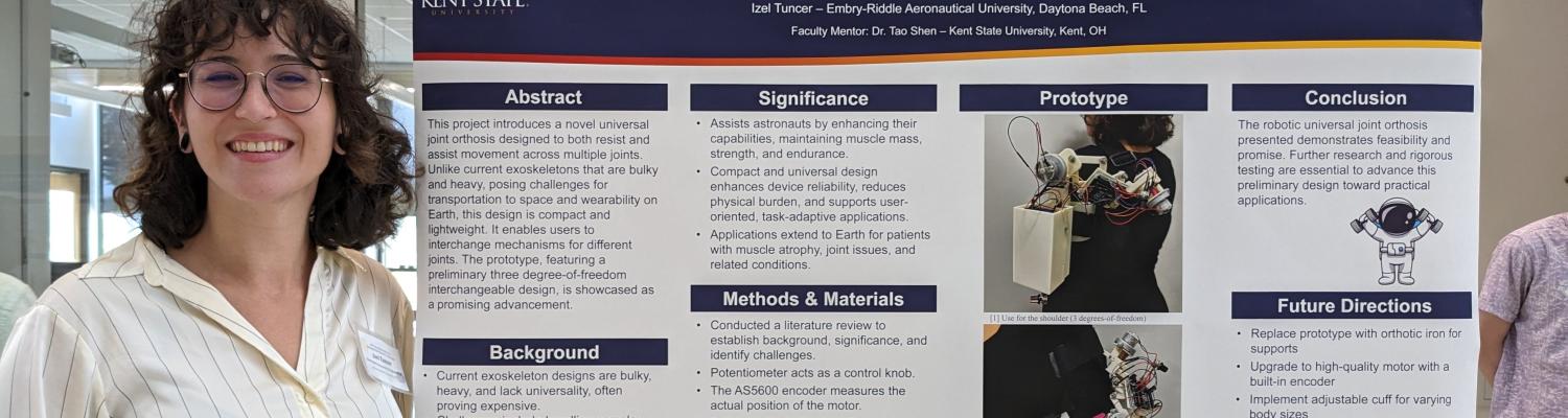 Engineering student Izel Tuncer stands next to a poster describing her project, "Unlocking Cosmic Strength: The Revolutionary Universal Joint Orthosis for Astronauts."