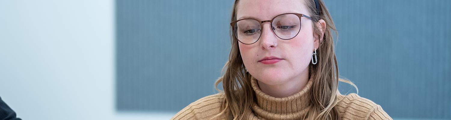 A photo of a young female student looking at her laptop