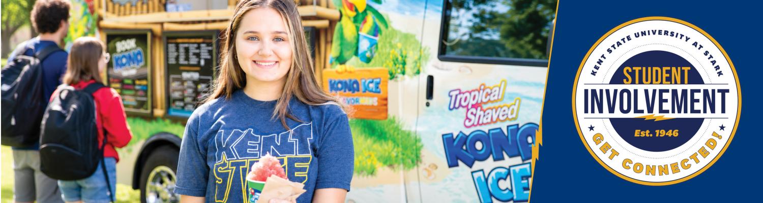 A female student getting shaved ice at a truck