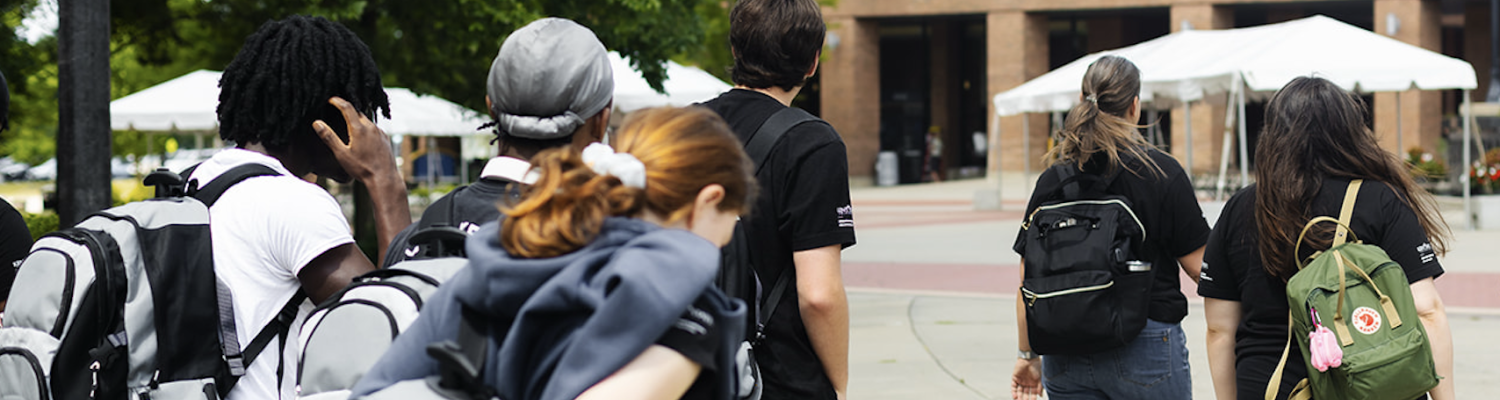Liberation Learners are walking in the courtyard of the student center.