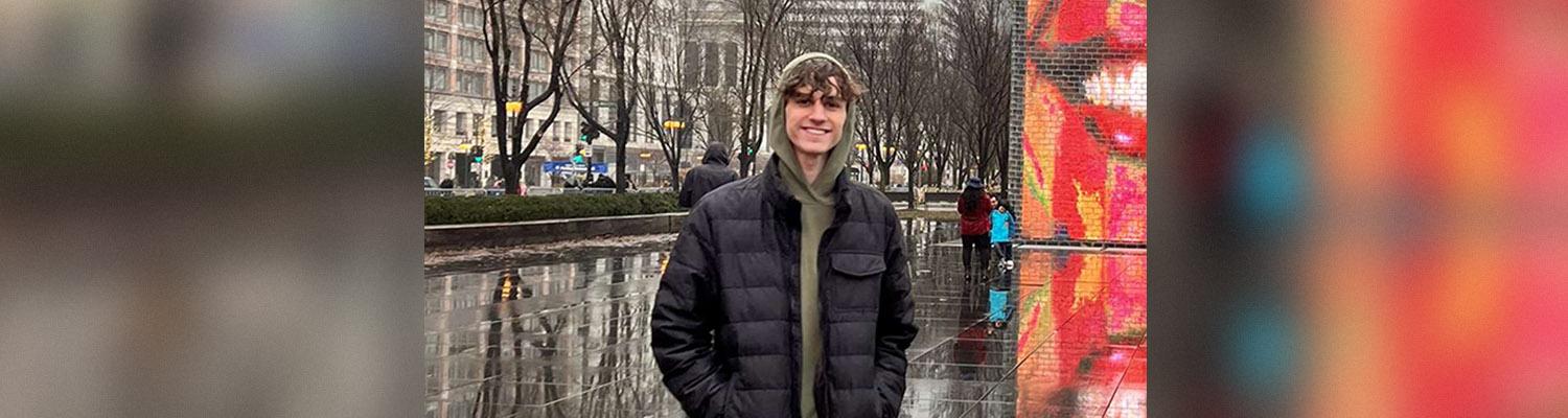 Student Ambassador standing out in the rain in a city