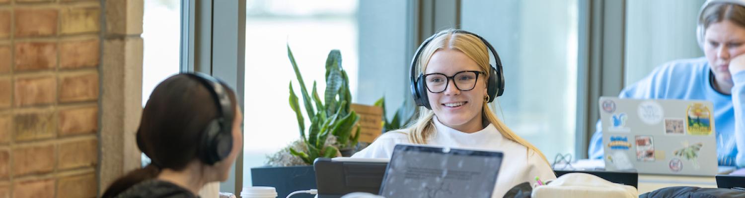 Two students sitting at a table and studying