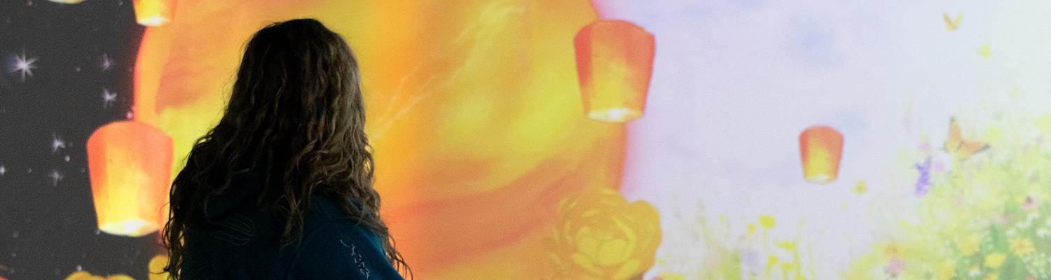 Back of a student looking at art