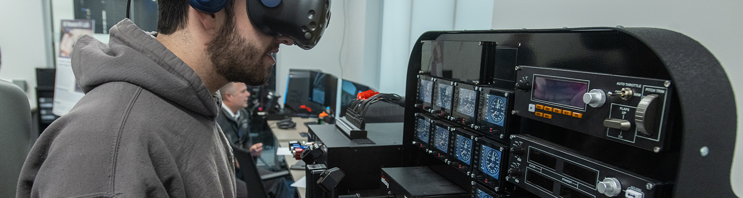 A student uses extended reality in a flight simulation