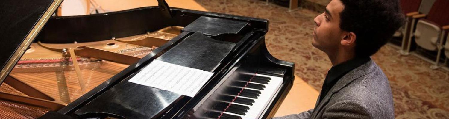 Photo of student playing a piano