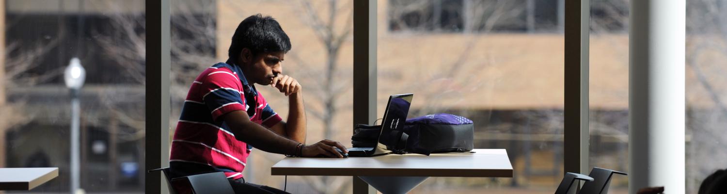 þҹӰԺѹۿ State student studies between classes on the second floor of the new Aeronautics and Technology Building.