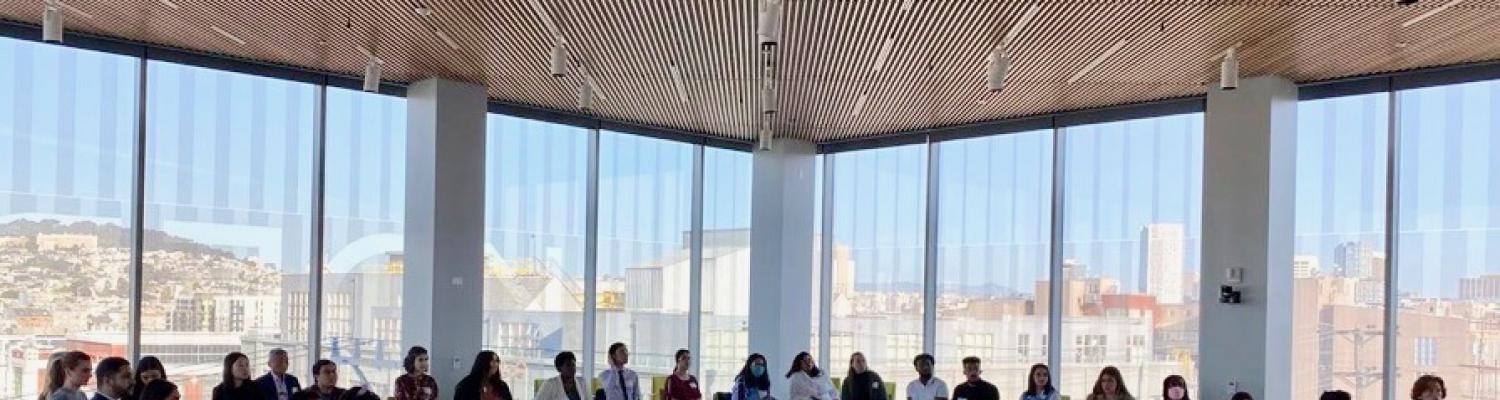 Photo of college students sitting around an L-shaped table for a National Millennial Community and Generation Z discussion.