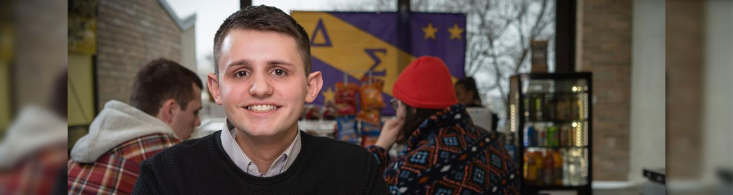Photo of student (John) posed and smiling for the camera