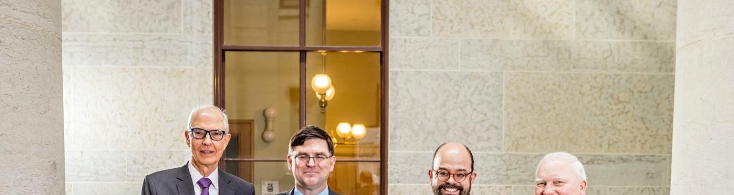 Four men are holding a large check from Ohio History Connection