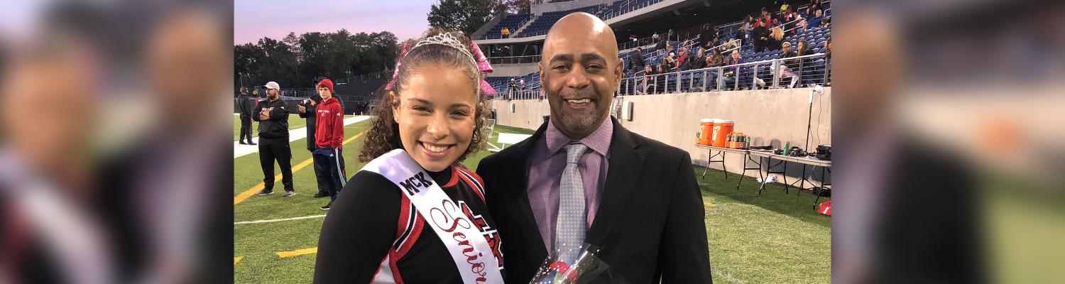 Photo of student (Steven) posed and smiling on a football field