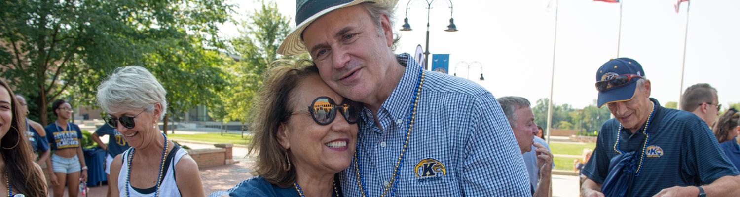 ������ President Todd Diacon and his wife, Moema Furtado, embrace during the Kiss on the K event during ������'s 2019 Homecoming.