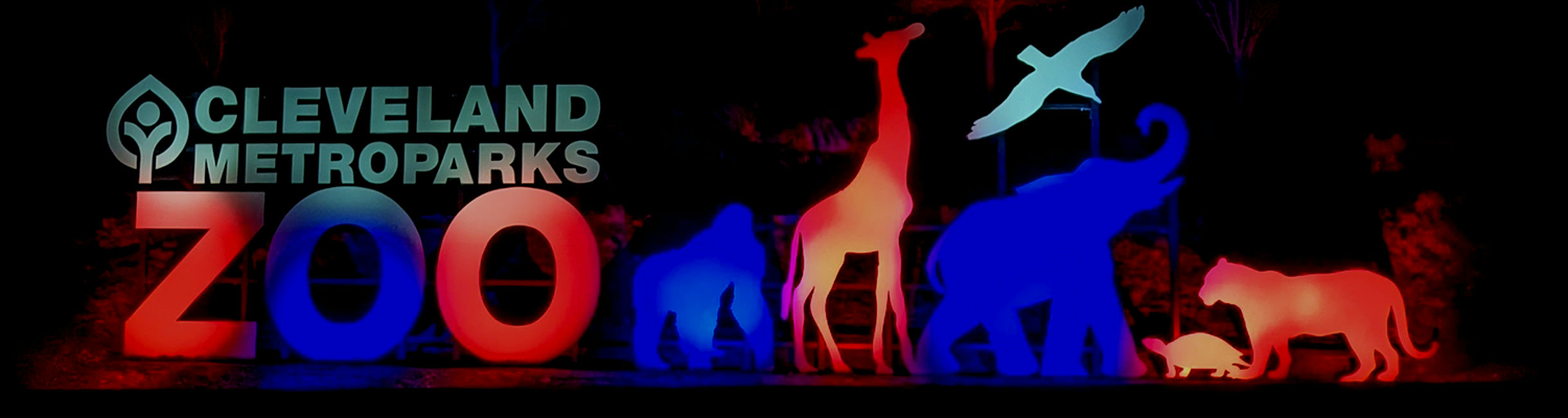 An illuminated sign for the Cleveland Zoo at night
