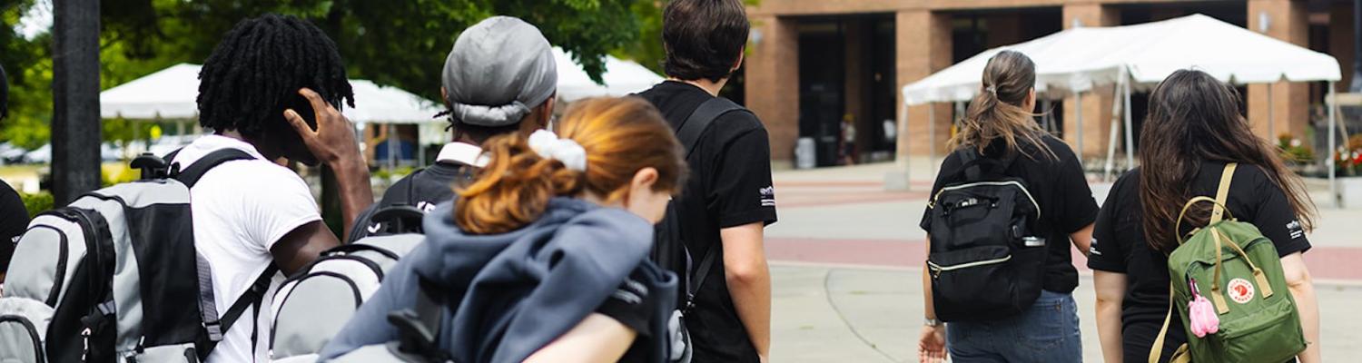 Liberation Learners are walking in the courtyard of the student center.