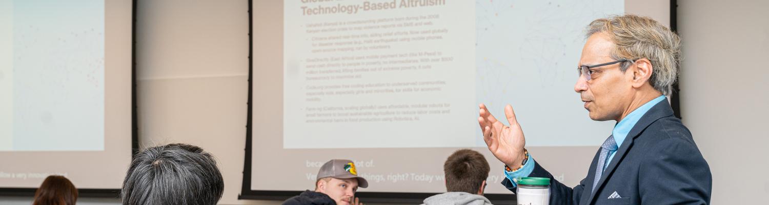 professor teaching a class as students look on. 
