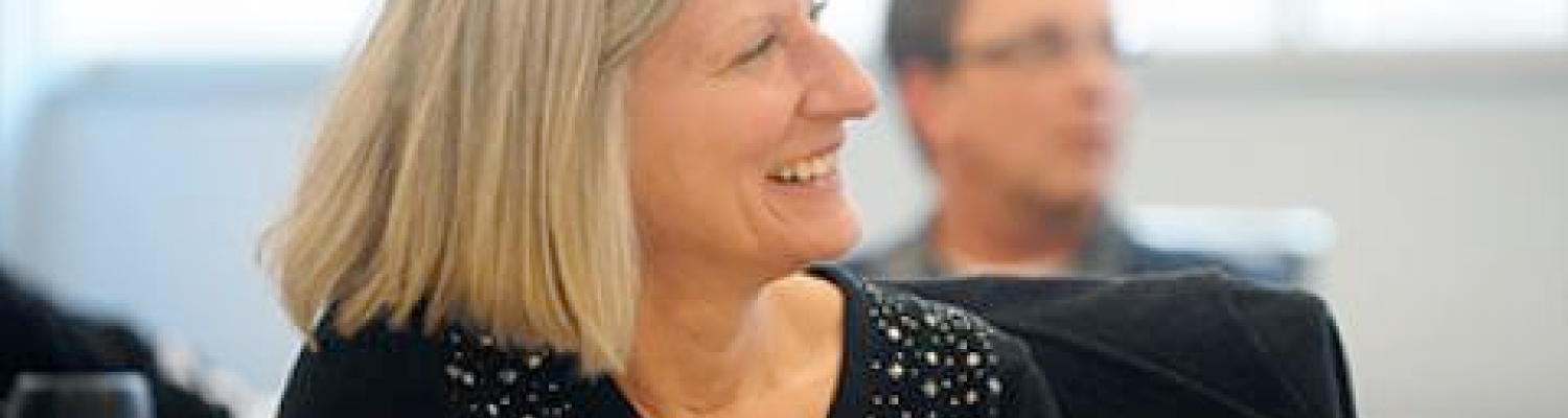 A program participant pays close attention to a speaker.