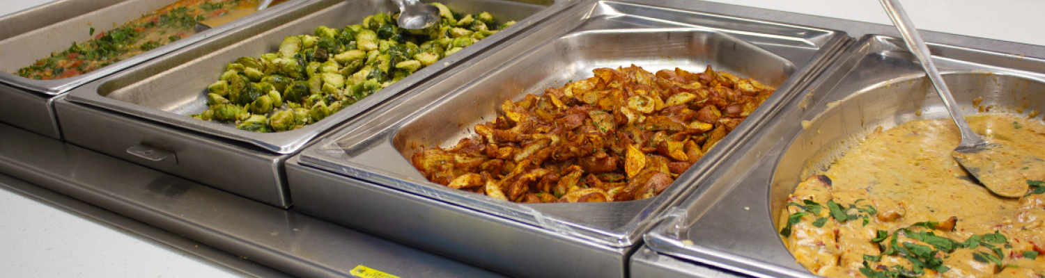 Spread of four trays each holding different food items