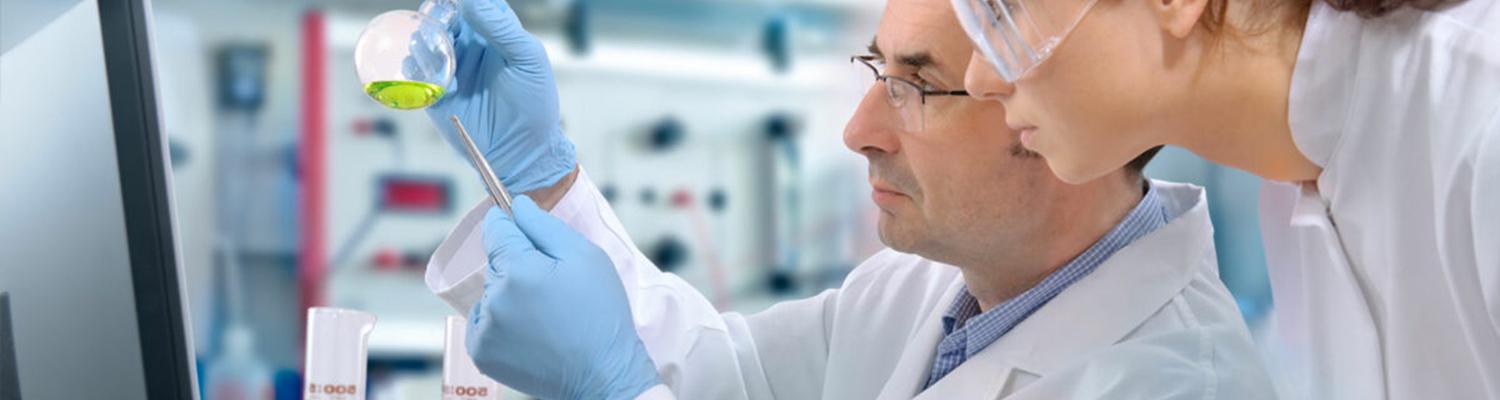 a female pharmacy student works in the lab with a male instructor