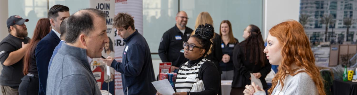 Participants gather around tables in the Crawford Hall atrium for the 2026 Career Fair.