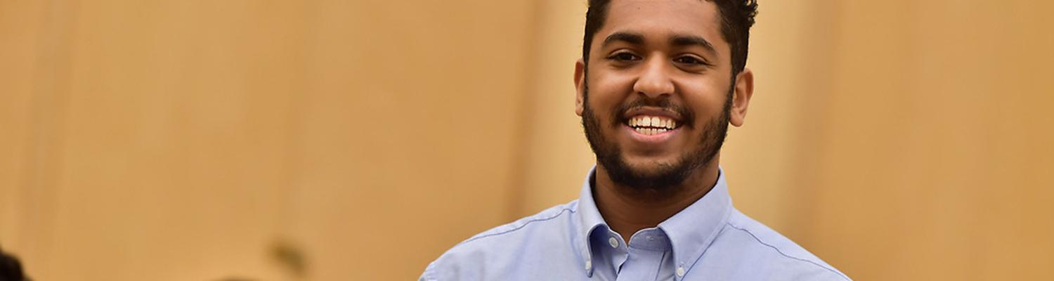 Student in classroom smiling