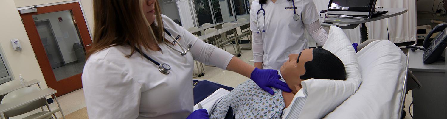 Two female nursing students in Ashtabula's high-fidelity simulator lab
