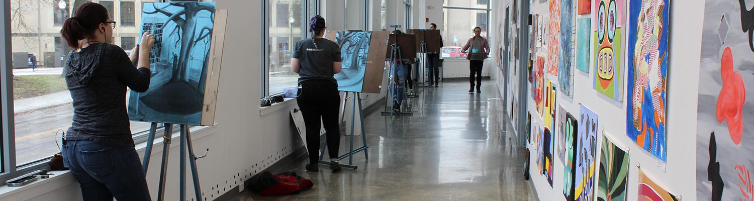 Students drawing in the hallway in the Center for the Visual Arts