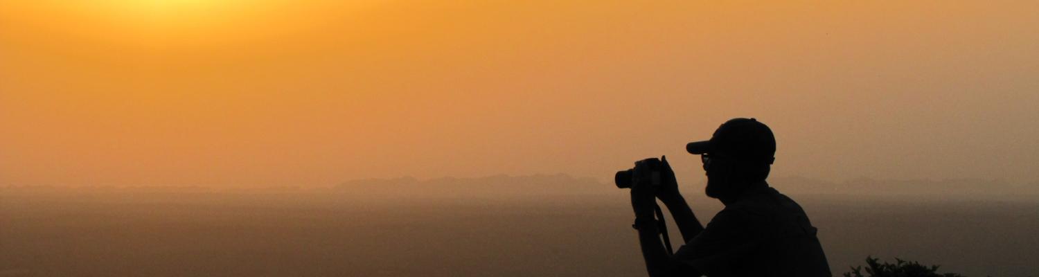 A geographer taking a picture at dusk